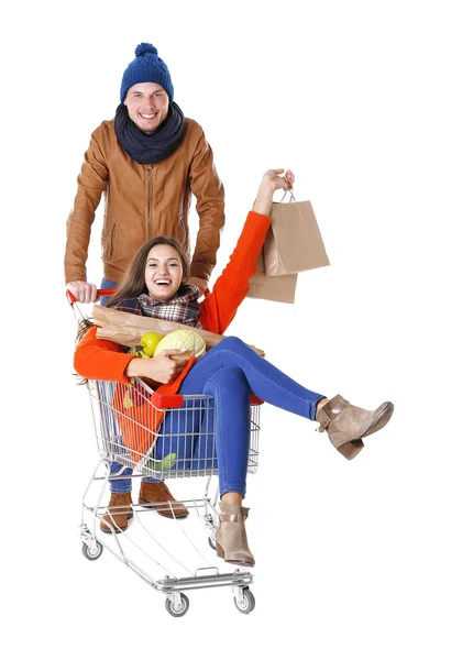Young man carrying woman in trolley isolated on white — Stock Photo, Image