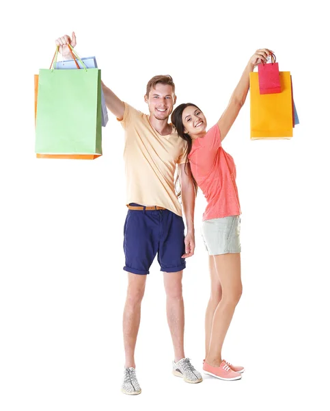 Happy couple with purchases isolated on white — Stock Photo, Image