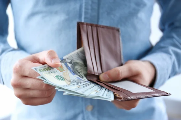 Man holding wallet with money, closeup Stock Photo