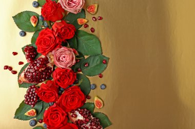 Gül, incir, yaban mersini ve nar adet renk arka plan üzerinde kompozisyon