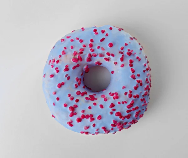 Tasty donut with sprinkles  on light background — Stock Photo, Image