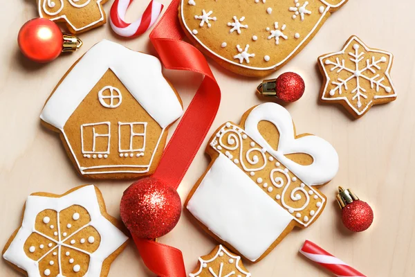 Tasty gingerbread cookies and Christmas decor on wooden background — Stock Photo, Image