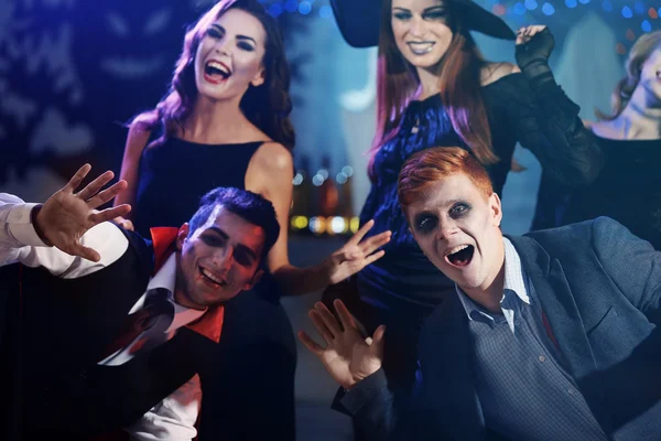 Young people in costumes having fun at Halloween party — Stock Photo, Image