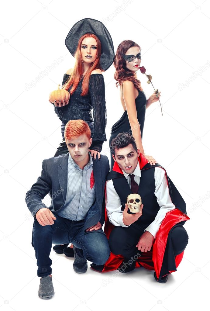 Young people dressed in different costumes for Halloween, isolated on white