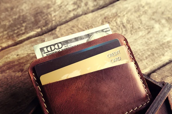 Deri cüzdan ve modern ahşap arka plan cihazlarda — Stok fotoğraf