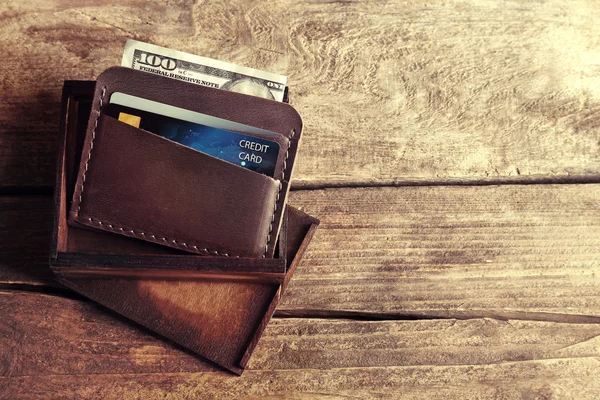 Leather wallet with money on wooden background — Stock Photo, Image