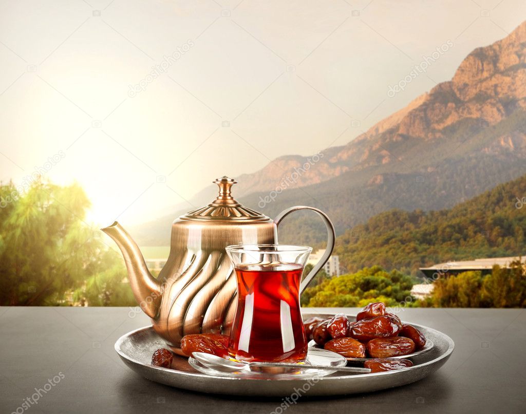 Composition for Turkish tea ceremony on table against landscape background. Culture heritage concept.