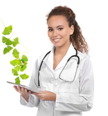 Genç kadın doktor tablet ve Ginkgo biloba ile beyaz zemin üzerine bırakır. Alternatif Tıp kavramı.