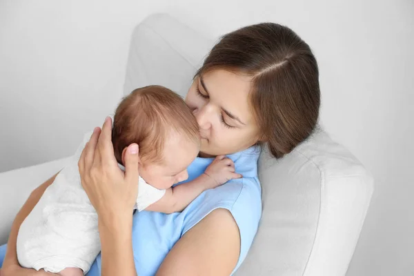 Ritratto di giovane donna che tiene in braccio il suo bambino, vista da vicino — Foto Stock