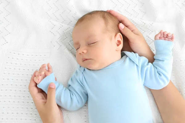Mother hands touching cute sleeping baby, close up view — Stock Photo, Image