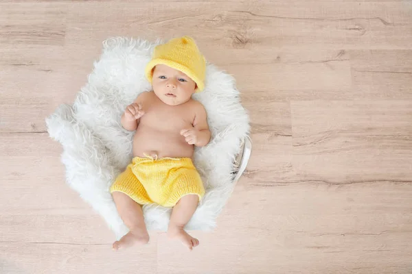 Aranyos baba fekvő bolyhos takaró, fából készült háttér — Stock Fotó