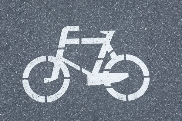 Bicycle sign on grey asphalt pavement, close up view — Stock Photo, Image