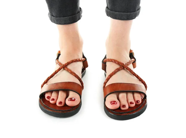 Brown leather sandals on woman's feet isolated on white — Stock Photo, Image