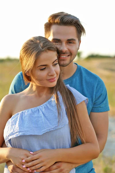 Beautiful young couple sensual hugging in the meadow — Stock Photo, Image