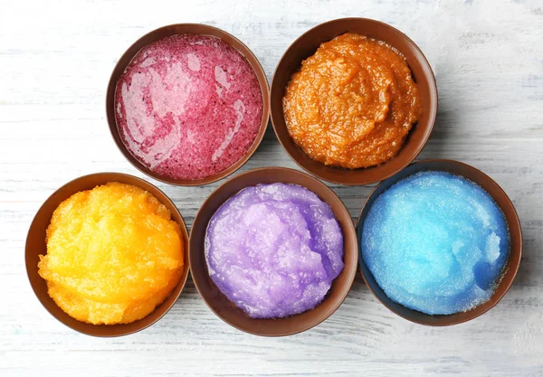 Body scrubs on wooden background — Stock Photo, Image