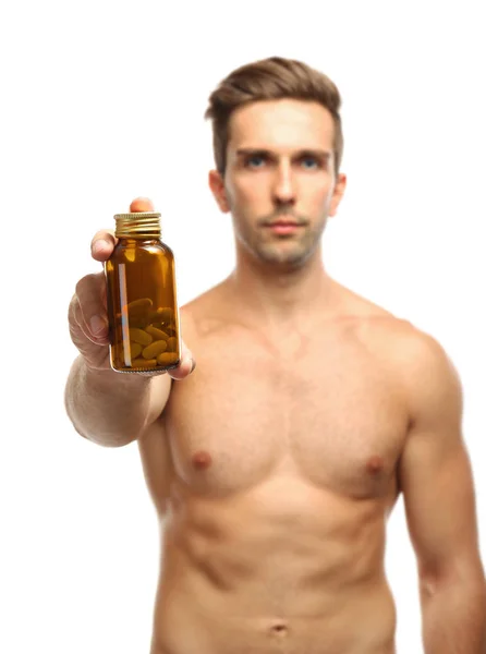 Homem muscular segurando drogas no fundo branco — Fotografia de Stock
