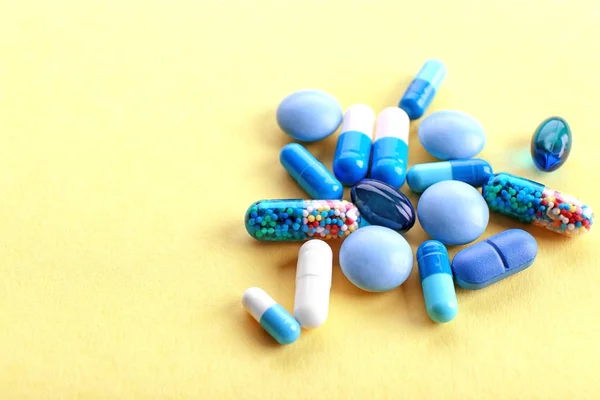 Heap of pills on yellow background — Stock Photo, Image