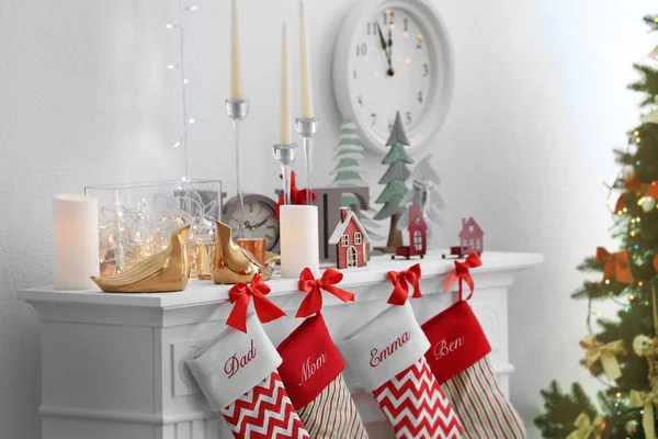 Christmas socks hanging on fireplace in room interior — Stock Photo, Image