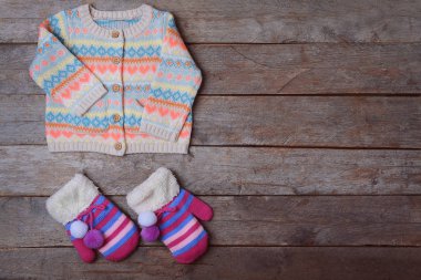 Sıcak ceket ve ahşap arka plan üzerinde renkli eldiven çifti