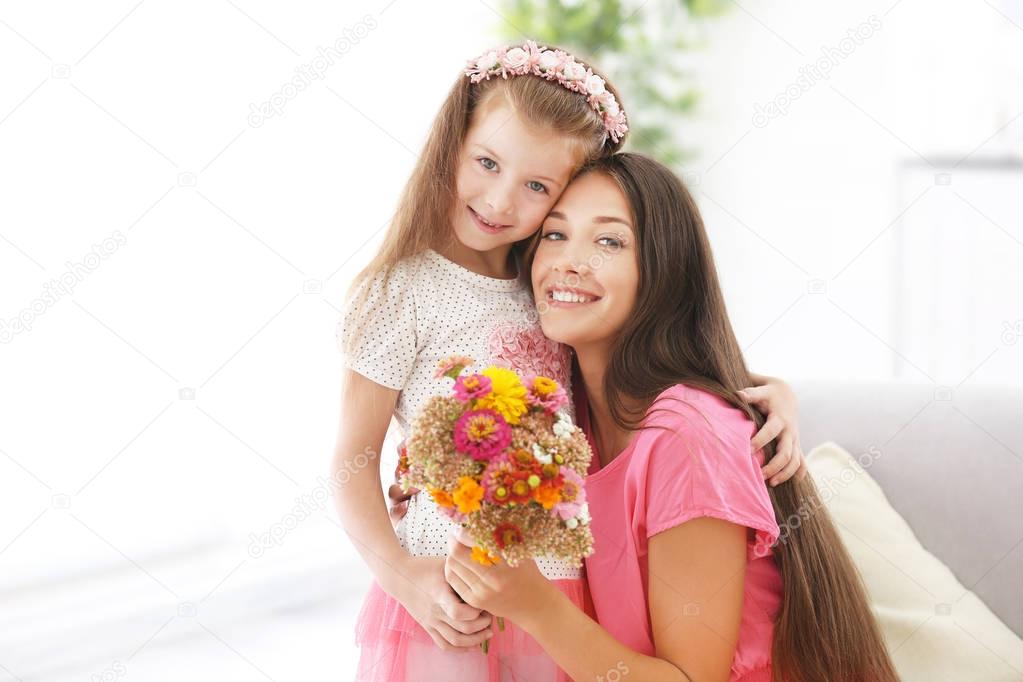 Greetings from daughter with flowers. Mothers day concept