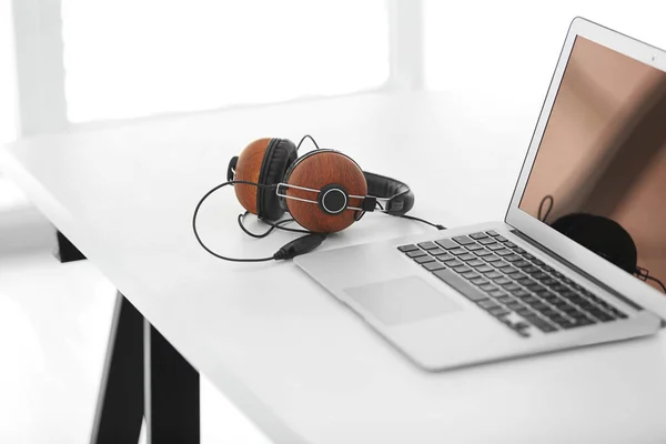 Laptop and headphones on office table