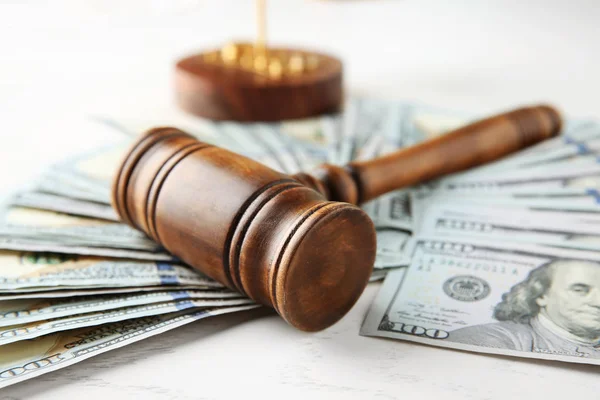 Judge's gavel and dollar banknotes on white table — Stock Photo, Image