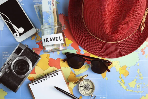 Traveller's accessories on world map background, top view. Travel planning concept — Stock Photo, Image
