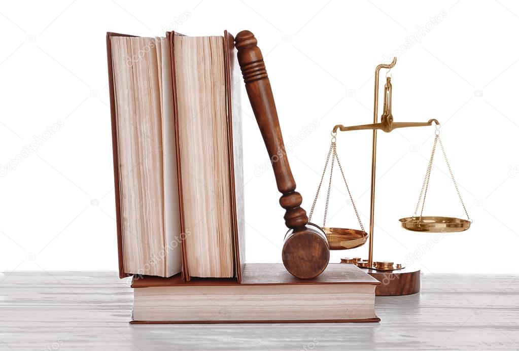 Gavel with books and scales on white background