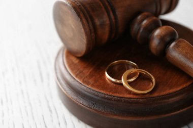 Golden wedding rings with judge gavel clipart