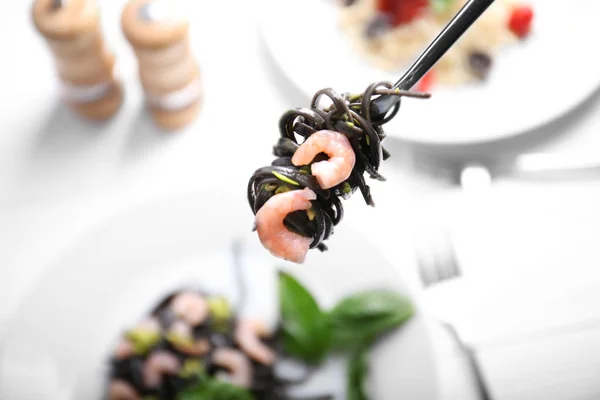 Fork with black pasta and shrimp — Stock Photo, Image