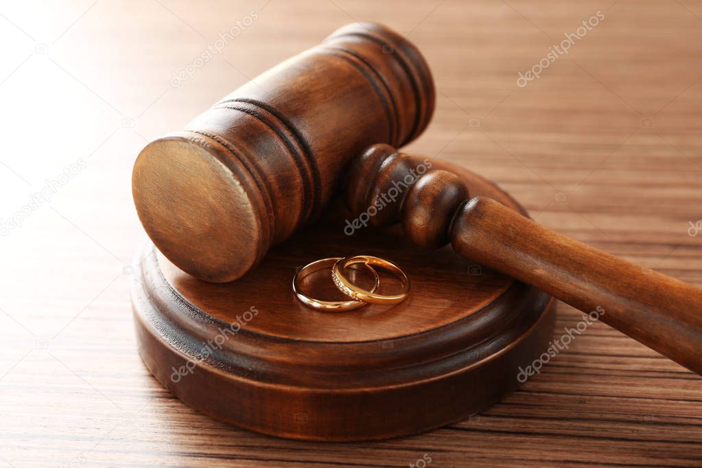 Golden wedding rings with judge gavel