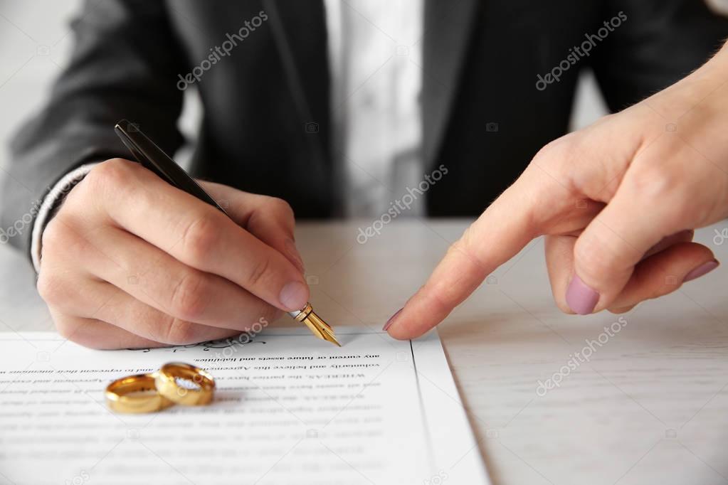 Man signing marriage contract
