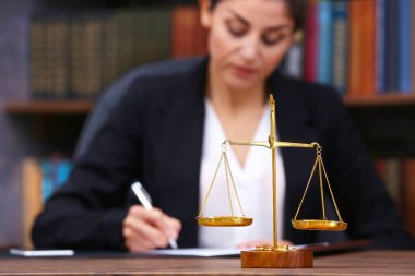 Scales of justice on wooden table  clipart