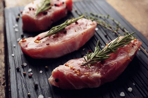 Raw steak with herbs — Stock Photo, Image