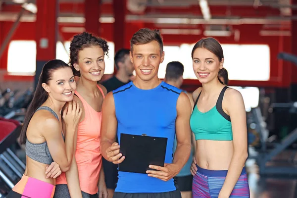 Group of women with personal trainer in gym