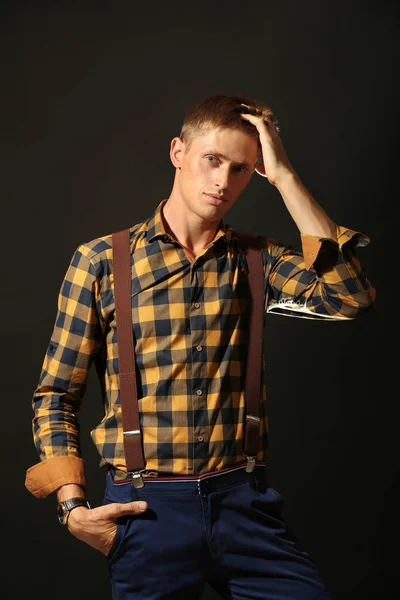 Young stylish man on dark background — Stock Photo, Image