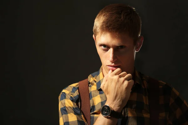 Young stylish man on dark background — Stock Photo, Image