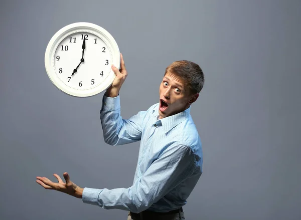 Man in shirt holding clock — Stock Photo, Image