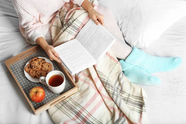 Girl with food reading book