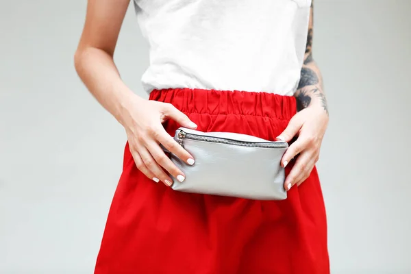 Stylish young woman with silver clutch — Stock Photo, Image
