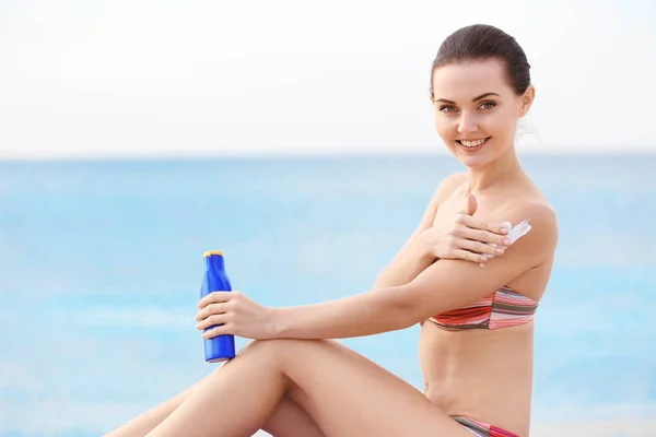woman applying sun protective lotion
