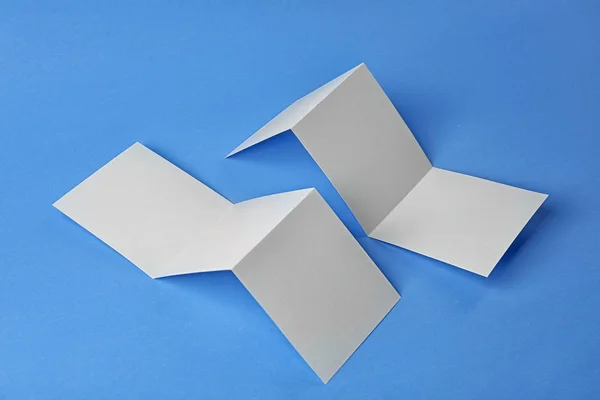 Blank booklets on blue background — Stock Photo, Image