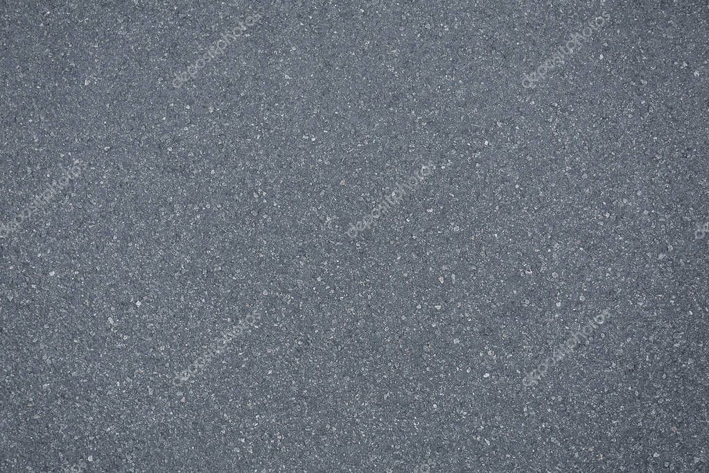 Close up view of grey asphalt pavement