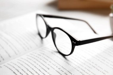 Glasses on open book clipart
