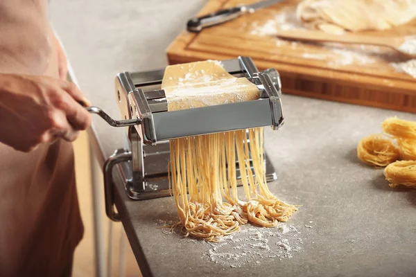 Man using pasta machine — Stock Photo, Image