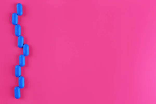 Color pills on pink background — Stock Photo, Image
