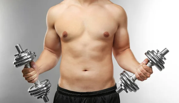 Sporty man with dumbbells — Stock Photo, Image