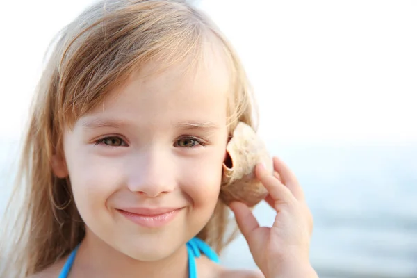 Roztomilá Dívka Poslouchá Mušle Moři — Stock fotografie