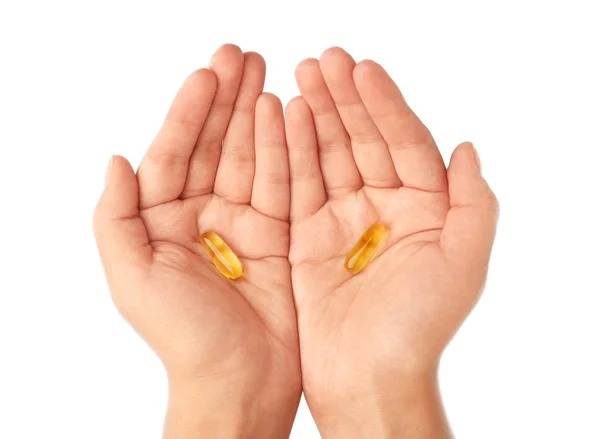 Hands holding Omega fish oil capsules — Stock Photo, Image