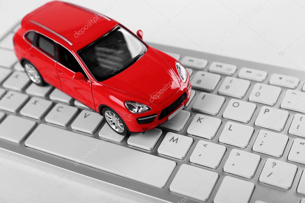 Red toy car on a keyboard